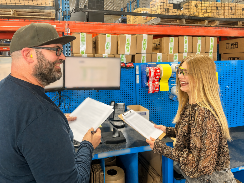 Minnesota Elevator Incorporated's Kaelyn Rahe is talking with a fellow employee inside MEI.
