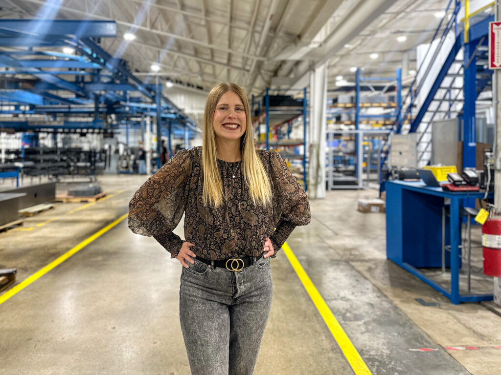 Kaelyn Rahe standing in the warehouse at Minnesota Elevator Incorporated.