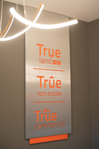 True Real Estate brand signage inside True office space
