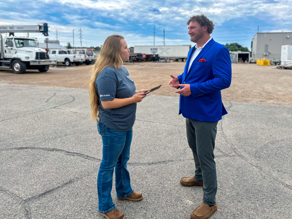 Danny Shaw talks with employee.