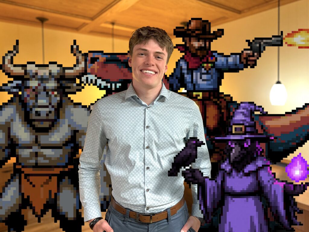 Cody Pithan with some of his card game characters behind him in the Lime Valley offices.